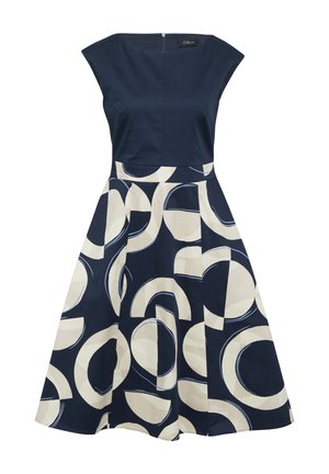 Robe bleu marine avec un corsage ajusté et une jupe évasée ornée d'un motif circulaire crème. Manches courtes et fermeture éclair invisible au dos.