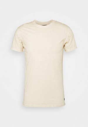 Helles beige Kurzarm-T-Shirt aus weicher Baumwolle, mit Rundhalsausschnitt und feiner Textur, versehen mit einem Logo-Akzent am Saum.