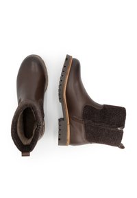 Bruine leren en wollen enkellaarzen met zijrits en rubberen zolen met profiel, één gezien van boven en één van opzij.