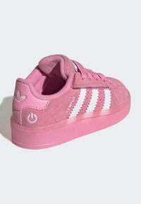 Pink suede Adidas Campus sneaker with white stripes, laces, and logo on the heel, shown from rear side on white background.