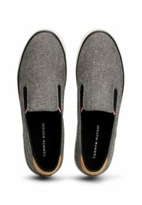Gray slip-on shoes with a textured fabric upper, black elastic side panels, white rubber sole, and a branded insole. Simple and casual design.