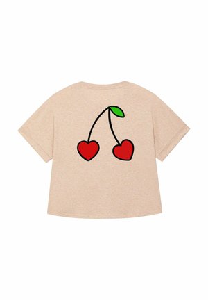 Beige oversized t-shirt met een afbeelding van twee rode kersen met een groene blad op de achterkant. Eenvoudig en casual ontwerp.