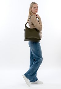 Olive green leather hobo bag with a smooth texture and a curved silhouette, featuring a top handle and minimalistic design.
