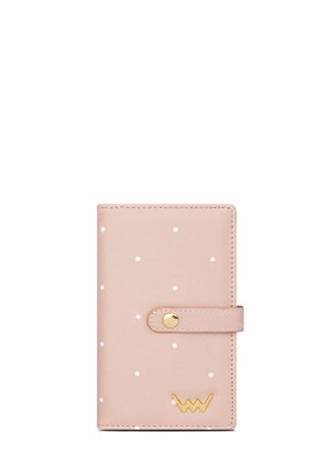 Pink wallet with white polka dots, made of smooth material. Features a snap button closure and a gold logo accent on the lower right.