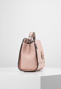 Rosa läderhandväska med en strukturerad form, som har silverfärgad hårdvara och blommiga accenter på ena sidan. Texturerad yta med svart kant.