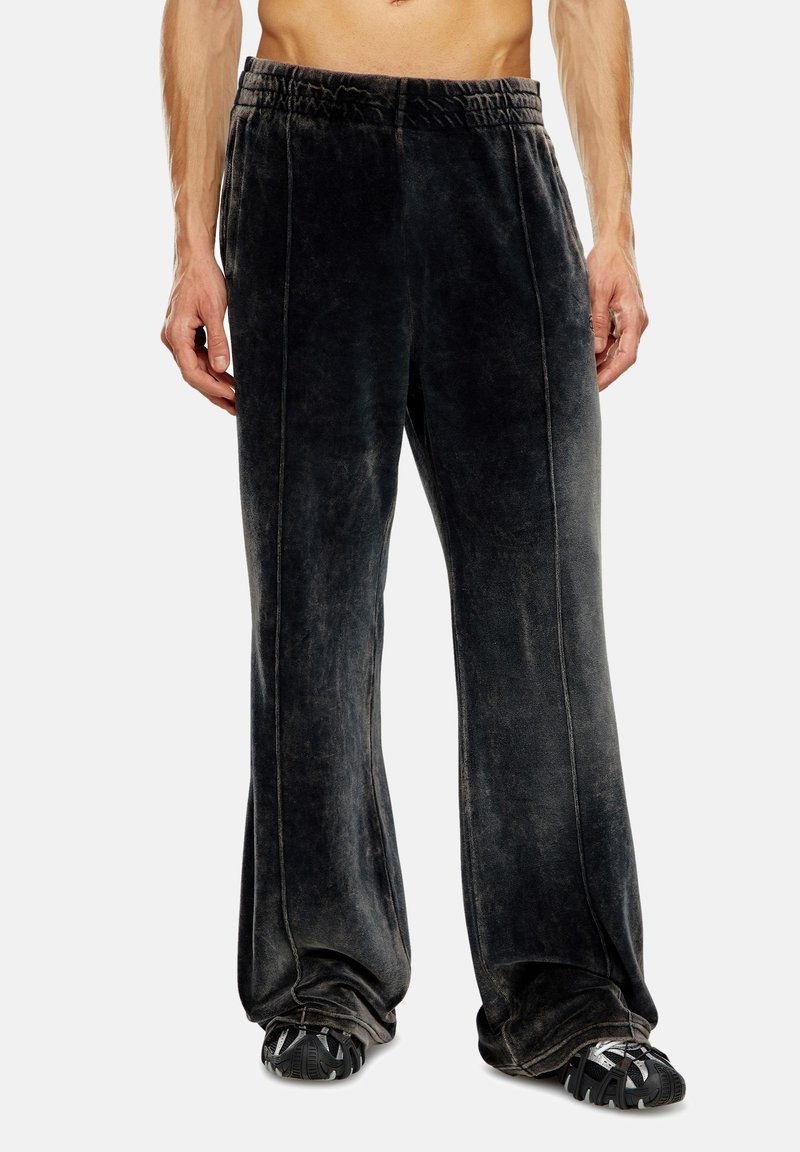 Schwarze Samtweitpants mit elastischem Bund und seitlichen Nähten. Strukturierter Stoff mit weichem Aussehen. Bequeme Passform.