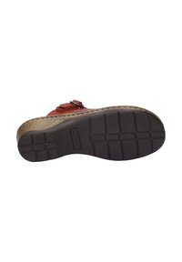 Red leather shoe with decorative buckle, textured sole, and intricately stitched edge. The sole features a grid pattern for traction.