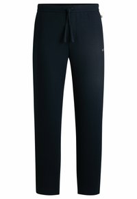 Marineblå joggebukser laget av teksturert stoff, med elastisk midje og snor, samt en subtil logodetalj på siden.