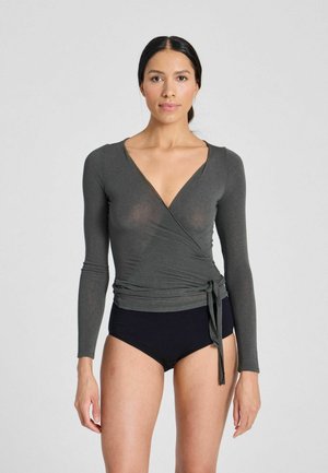 Long-sleeved, deep gray wrap top featuring a V-neckline and tie detail at the waist. The fabric appears slightly sheer. Paired with black bottoms.