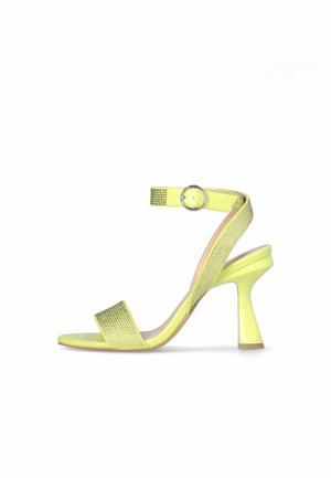 Yellow high-heeled sandal with a glossy finish, two wide straps, and an ankle strap featuring a circular metallic buckle. Textured accent on strap.