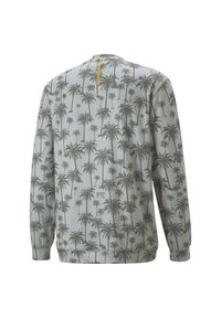 Felpa grigia chiara con un motivo di palme scuro su tutta la superficie, caratterizzata da un accento giallo sul retro del collo e polsini elasticizzati.