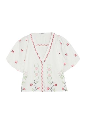 Blusa blanca de manga corta con ribete en zigzag rojo y bordado floral en rojo, verde, rosa y negro, con escote en V y corte amplio.