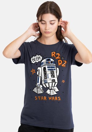 Navy blue t-shirt featuring a graphic of R2-D2 from Star Wars, with orange accents and text saying "BEEP!" and "R2-D2". Soft fabric, casual fit.