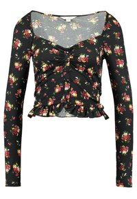 Svart långärmad topp med blommönster, rynkat framstycke och volangnederkant. Tillverkad av strukturerad tyg med fyrkantig halsringning.