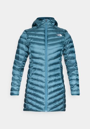 Teal puffer jacket with a zip front and hood. Features horizontal and chevron quilting patterns, lightweight fabric, and a fitted design.
