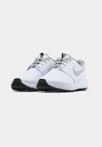 White athletic shoes with a smooth material, silver accents, rounded toe, and black rubber sole. Laces are gray, with a reflective detail.