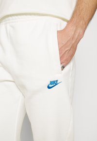 Nike Sportswear Tracksuit bottoms - off-white