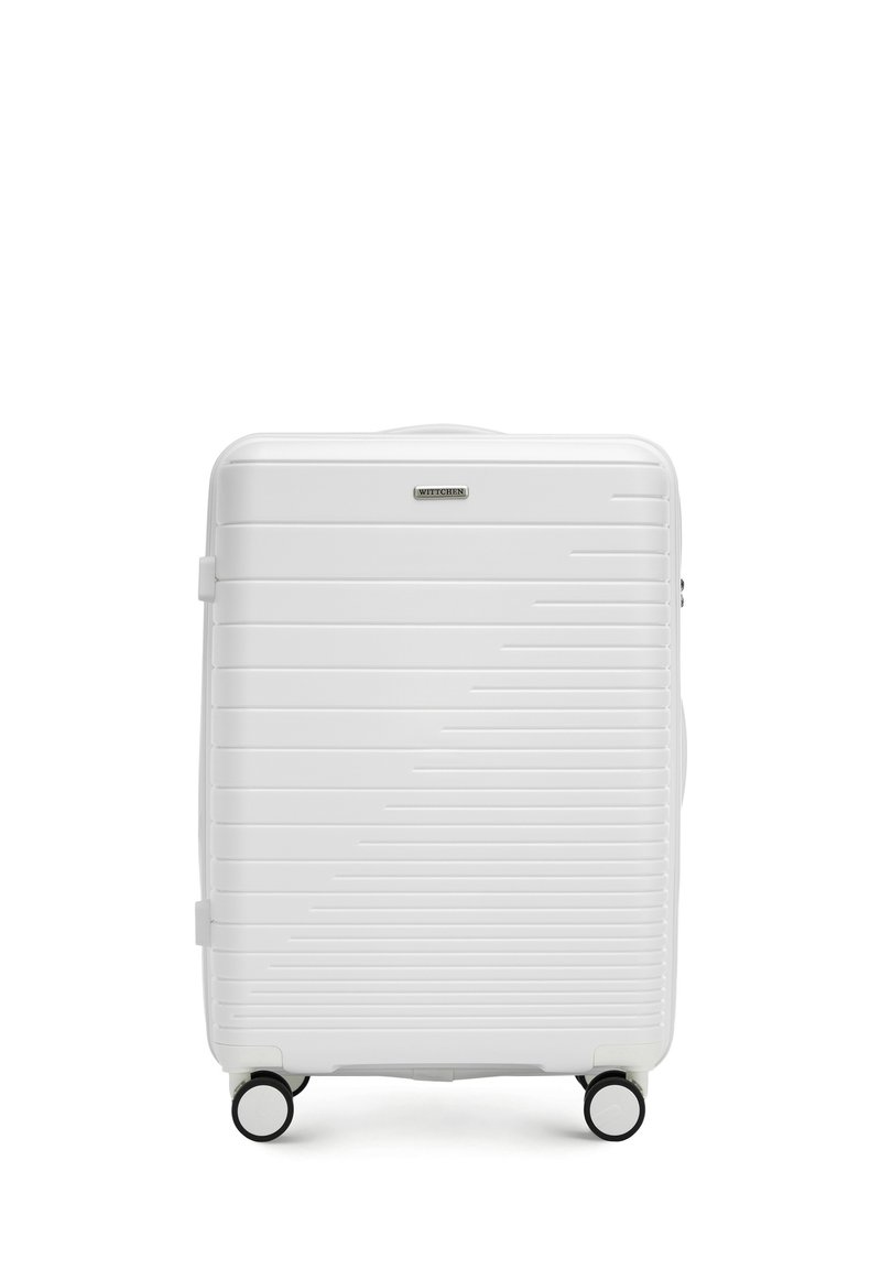 White hard-shell suitcase with horizontal grooves, black wheels, and a top handle. Features a brand logo on the front. Rectangular shape.