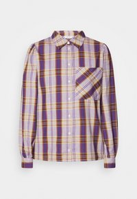 Long-sleeve plaid shirt in purple, yellow, and cream. Features a pointed collar, button front, and a chest pocket with diagonal pattern.