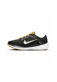 Black and mustard running shoe with white sole, light green Nike swoosh, mesh upper, and lace-up closure.