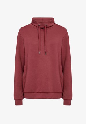 Tumesinine pusa kõrge, voltitud kraega, nööridega, pikkade varrukatega ja lõdva lõikega. Valmistatud pehmest, kergest kangast.