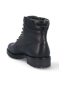 Bottine en cuir noir avec un bout rond, un laçage à l'avant et un dos texturé. Elle est dotée d'une semelle en caoutchouc robuste et de coutures renforcées.