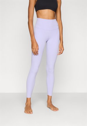 Light lavender high-waisted leggings made from stretchy material, fitted design, with a smooth texture and minimal branding on the waistband.