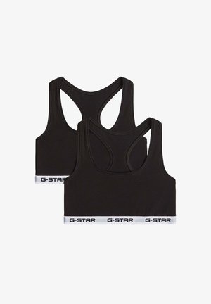 Deux brassières de sport noires avec dos nageur, bandes élastiques blanches à l’ourlet, chaque bande présentant le texte noir « G-STAR » répété.