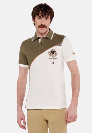 Polo in tessuto cotone con un design a blocchi di colore verde e bianco, logo ricamato e dettagli a righe sul colletto e sulla spalla.
