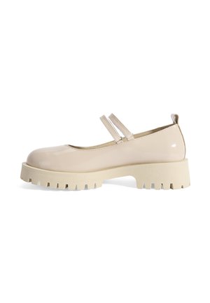Beige gepatineerd leren Mary Jane schoenen met twee banden, ronde neus, dikke witte zool en gestructureerde groeven voor grip.