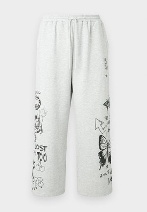 Light gray jogger pants made of soft fabric with black printed designs, including a butterfly, skull, and text, featuring an elastic waistband.
