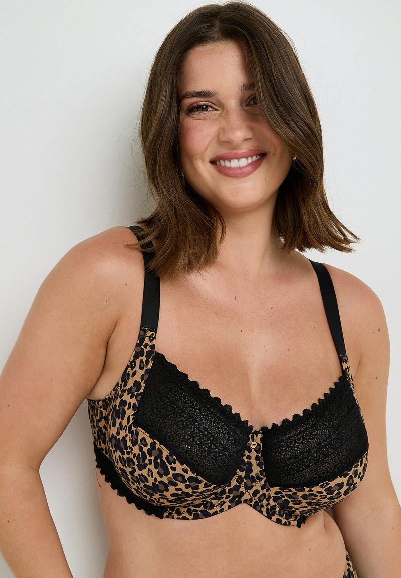 Reggiseno con stampa leopardata, rifinito con pizzi neri, bordi ondulati e spalline regolabili. Presenta una chiusura anteriore sicura e una texture morbida.