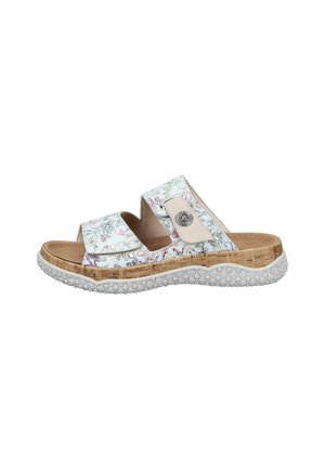 White and beige slip-on sandal with floral pattern, two adjustable straps, cork-textured midsole, and textured white rubber outsole.