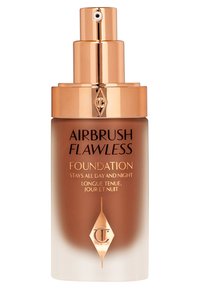 Airbrush Flawless Foundation with a frosted brown bottle, gold accents, and a pump top. Text in black and gold detailing on the front.
