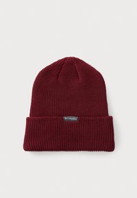 Burgundy knitted beanie with a ribbed texture and a folded cuff. Features a small black Columbia tag on the front.