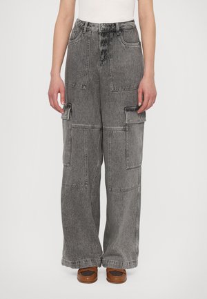Gray denim cargo pants featuring a wide-leg cut, multiple utility pockets, and a high waist design. Smooth texture with slight fading.