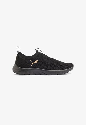 Black slip-on athletic sneaker with knit upper, flexible sole, pull tabs, and gold Puma logo on side, shown in side profile.
