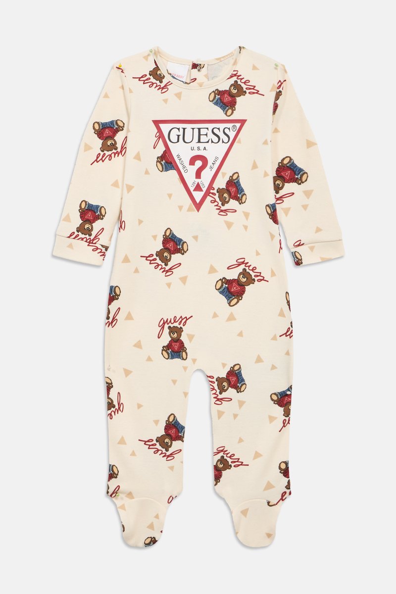 Kermanvalkoinen vauvan body, jossa on kaikkialla nallekarhukuviot ja "Guess"-tekstiprintti, ja rinnassa suuri punainen kolmionmuotoinen Guess-logo.