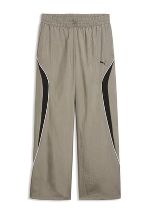 Pantalon de survêtement beige à jambes larges avec taille élastique, panneaux latéraux noirs incurvés, passepoil blanc et petit logo Puma sur la cuisse droite.
