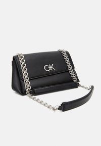 Black leather handbag with a silver chain strap, rectangular shape, featuring a logo emblem and a textured surface. Fold-over flap design.