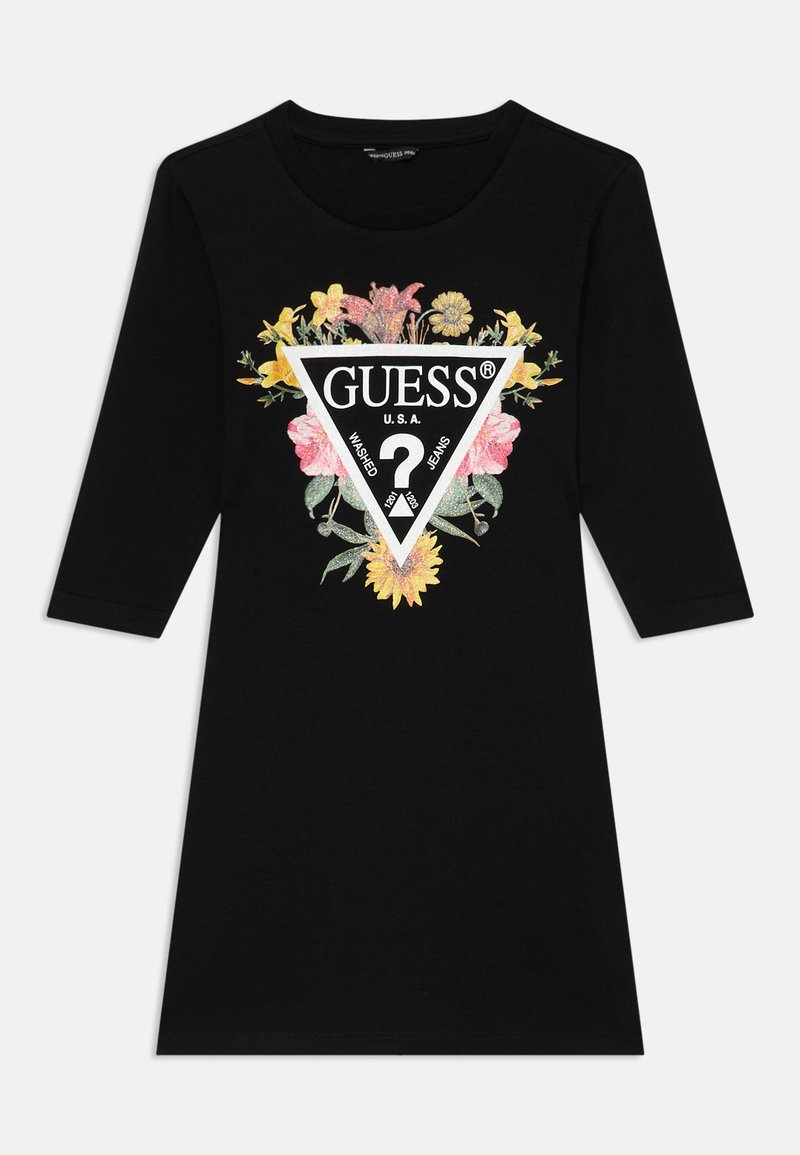 Black cotton dress with three-quarter sleeves; features a floral graphic surrounding a white triangle with "GUESS" logo and text.
