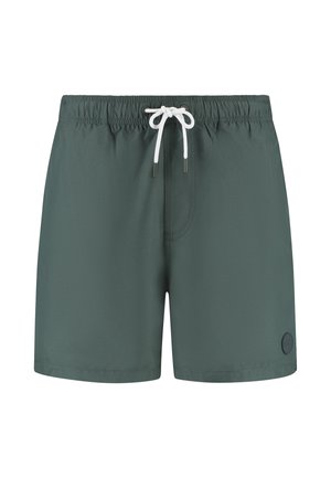 Pantaloni da bagno verde scuro con vita elasticizzata e cordino bianco. Presenta un piccolo logo sul lato inferiore destro. Materiale leggero.