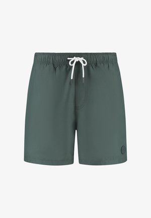 Pantaloni da bagno verde scuro con vita elasticizzata e cordino bianco. Presenta un piccolo logo sul lato inferiore destro. Materiale leggero.