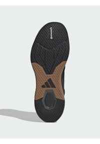 Μαύρη καουτσούκ σόλα παπουτσιού με υφές για καλύτερη πρόσφυση, που διαθέτει καφέ τμήμα απόσβεσης στη μέση και εμφανές λογότυπο της Continental.