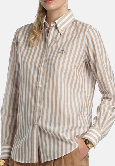 Beige and white striped shirt in lightweight fabric with a button-down collar. Features a small embroidered logo and cuff detail.