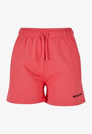 Korallivärvi puuvillased lühikesed püksid elastse vöökoha ja paelaga. Omab küljetaskuid ja musta logo detaili alumisel küljel.