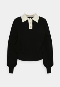 Pull en maille noire avec un col polo crème contrastant et trois boutons décoratifs. Doté de manches larges et d'un ourlet court.