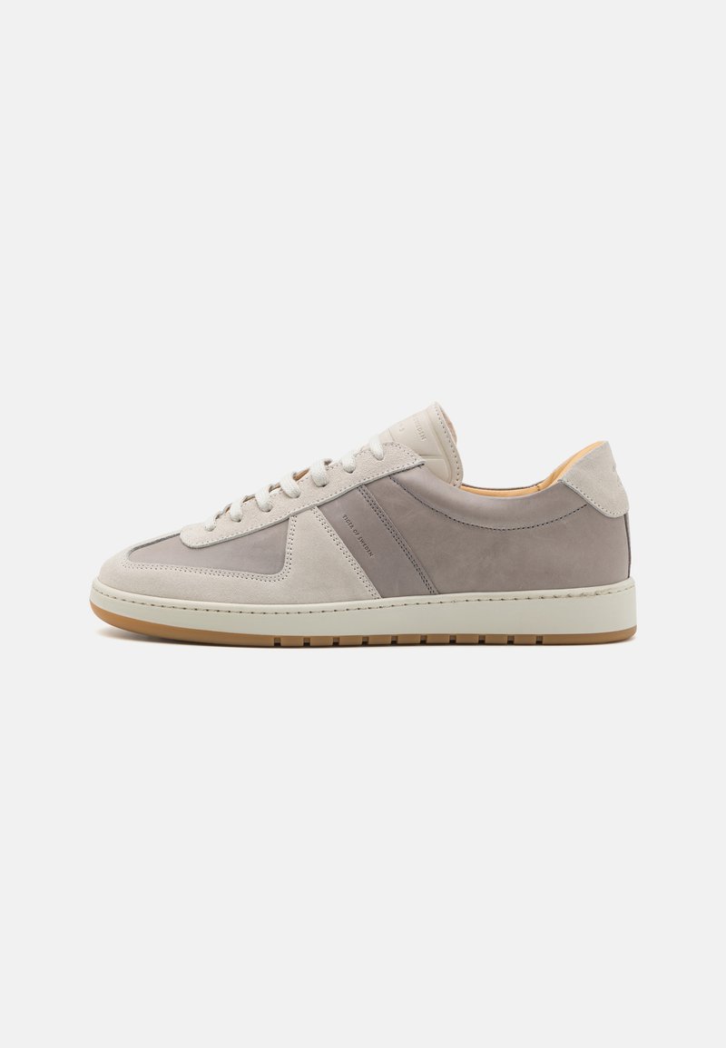Men’s sneaker in light gray and taupe suede, featuring a rubber sole, lace-up design, and subtle side panel accents.