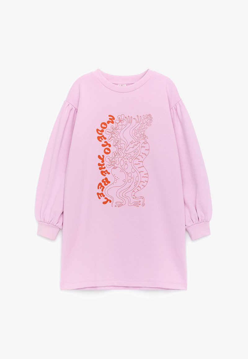 Robe lilas à manches longues avec poignets froncés, présentant un motif abstrait rouge ressemblant à du corail et un texte rouge ondulé aligné verticalement à l’avant.