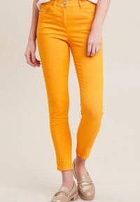 Oranje denim skinny jeans met een gladde textuur, hoge taille en een slim fit. Voorzien van een knoopsluiting en zichtbare voorzakken.